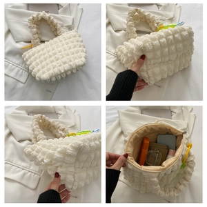Detail of white bubble textured tote bag showing large capacity for daily items and accessories