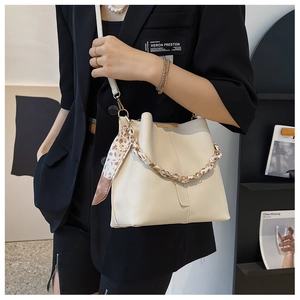 Detail of off-white bucket bag with leopard print silk chain strap and smooth leather