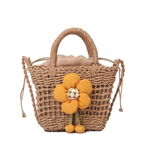 Handmade straw bucket bag with orange flower and drawstring lining for summer beach holidays