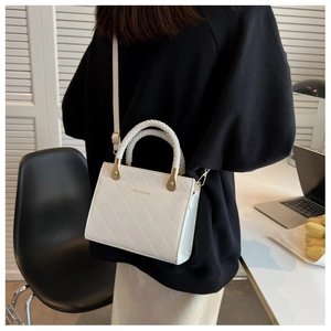 Quilted white crossbody bag on a model in a modern office, showing its size and style