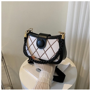 Detail view of white quilted bag with brown argyle pattern and black buckle decoration
