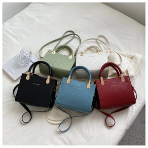 Detailed display of quilted tote bags in five colors with woven handles and straps