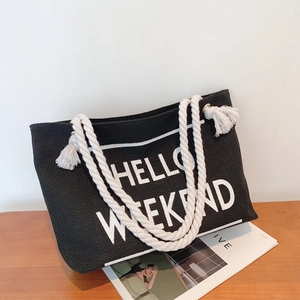 Retro black canvas tote bag with Hello Weekend print and white rope tassel handles