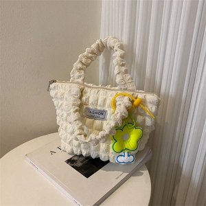 Chic pleated bubble tote bag in creamy white with floral charm and zip closure