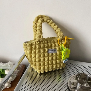 Yellowish green popcorn fabric shoulder bag with flower charm and textured design