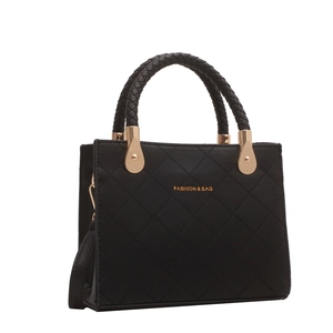 Elegant black quilted handbag with woven handles and golden hardware shown from a side angle