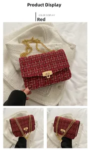 Detail view of red tweed crossbody bag with golden chain strap and metallic press lock