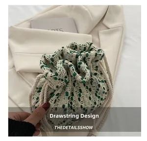 Detail shot of green and white woven bucket bag showing drawstring closure and texture