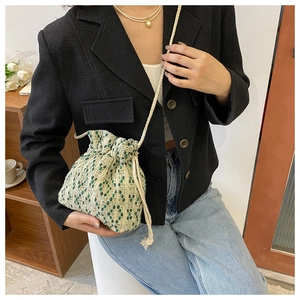 Detail of woven geometric pattern drawstring crossbody bag with cotton rope strap