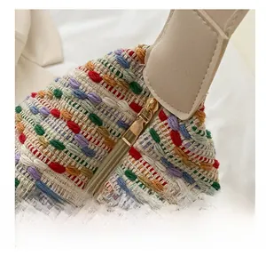 Close-up of smooth golden metal zipper and colorful woven fabric on a tote bag