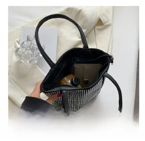 Interior view of the black rhinestone bucket bag showing space for phone and wallet