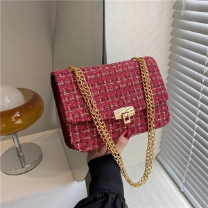 Classic red tweed crossbody bag with gold chain strap and metal lock closure