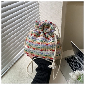 Close-up of colorful striped woven bucket bag with cotton drawstring handle and texture