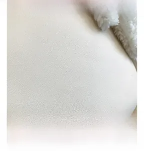 Close-up of premium white lychee grain leather and soft faux fur stitching detail