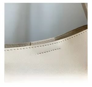 Macro detail of high-quality stitching and fine leather texture on stylish tote bag