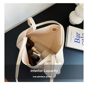 Detail showing the large interior capacity of this cream soft leather tote with magnetic clasp