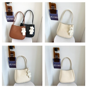 Detailed grid view of minimalist faux leather tote bags with cute plush bear charms