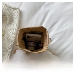 Interior view of khaki drawstring bag showing storage for phone and lipstick
