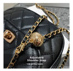 Detail of adjustable golden ball buckle on black quilted leather chain strap bag