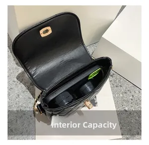 Internal capacity of black quilted crossbody bag showing storage for phone and makeup