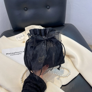 Chic black pleated drawstring bucket bag with large organza bow and pearl necklace accents