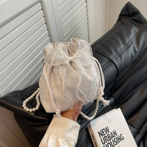 White pleated bucket bag with mesh bow and elegant pearl strap for women