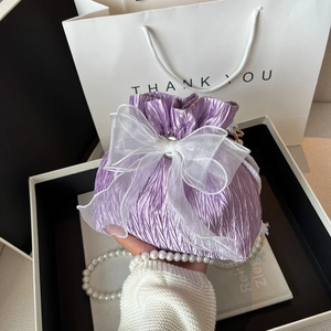 Lavender pleated drawstring bucket bag with organza bow and pearl strap handle