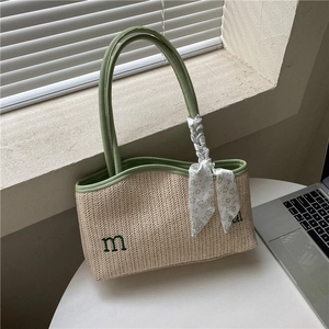 Large straw tote bag with avocado green trim and floral scarf detail for summer