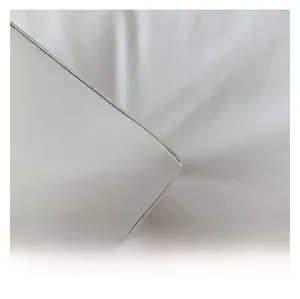 Macro shot of white matte textured faux leather surface with precise edge stitching