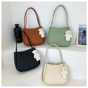 Detail view of colorful tote bags in four matte shades with cute teddy bear charms