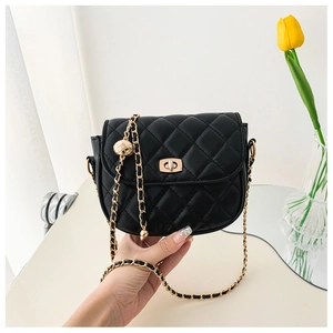Detail of black quilted chain bag with gold sphere accent and metallic turn-lock closure