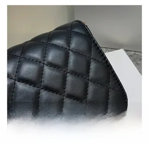 Detailed close-up showing the precise stitching and quilted leather pattern on a black bag