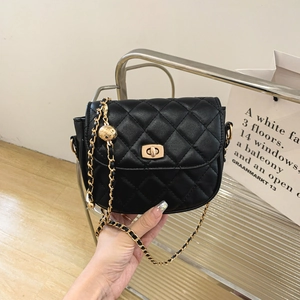 Black quilted shoulder bag with gold chain strap and decorative hollow metal ball charm