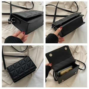 Detailed view of black quilted crossbody bag showing texture, side profile and inner storage