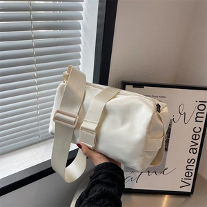 Fashionable beige nylon crossbody pillow bag with wide adjustable shoulder strap