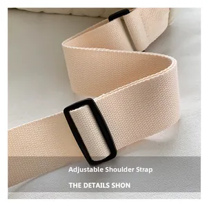 Detail of adjustable off-white woven shoulder strap with black buckle for crossbody bag