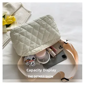 Capacity display of white quilted puffer crossbody bag with daily essentials inside