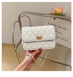 Close-up of white quilted leather bag featuring a gold twist-lock and metal chain strap