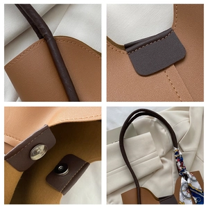 Détail du cabas caramel montrant le cuir grainé, les coutures et le foulard en soie
