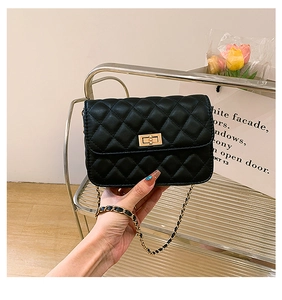 Detail of black quilted leather shoulder bag with gold twist lock and chain strap
