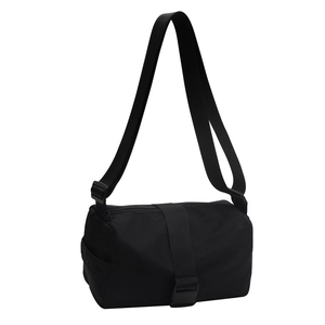 Black waterproof nylon messenger bag in a sleek cylinder shape with wide webbing straps