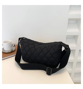 Detailed view of black quilted crossbody bag with adjustable strap and soft nylon texture
