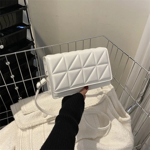 White quilted rectangular shoulder bag with adjustable strap and geometric triangle stitching