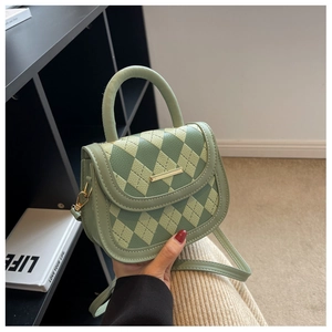 Detail of light green argyle mini handbag featuring PU leather texture and metal buckle