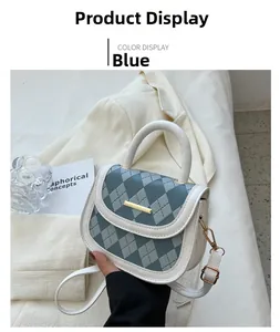 Close-up of blue and white quilted leather handbag with gold clasp and elegant textures