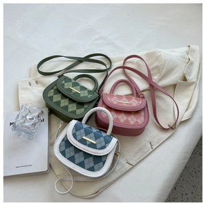 Detail of quilted saddle bags in pink and green with elegant golden metal clasps
