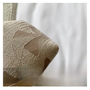 Macro shot of jacquard fabric detailing 3D geometric patterns on a vintage handbag