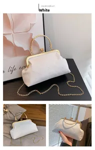 Detail of white vintage frame bag with jacquard texture and golden ring handle