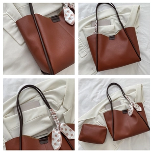 Close-up of brown tote bag with pink polka dot scarf and matching small zipper pouch