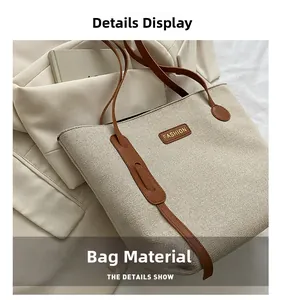 Detail shot of the durable canvas fabric texture and brown leather strap on the tote bag